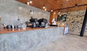 a bar in a restaurant with a counter top at La Levée Resort in Sai Yok