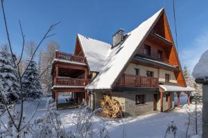 a house with a snow covered roof at RentPlanet - Śpiący Rycerz in Zakopane