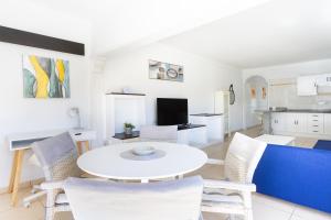 un salon avec une table et des chaises blanches dans l'établissement Tranquilidad, playa y vistas al mar, à Callao Salvaje