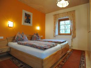 a bedroom with a bed and a window at Ferienhaus Nickl in Weissbriach