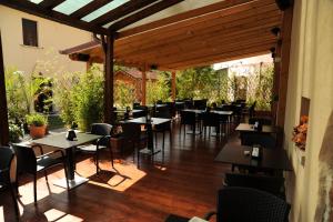 ein Restaurant mit Tischen und Stühlen auf einer Terrasse in der Unterkunft Hotel Scaldaferro in Sandrigo