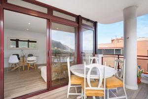 a dining room with a table and chairs on a balcony at Casa Vista Faro in Las Lagunas