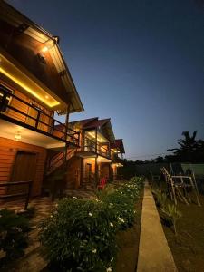 a house with a garden in front of it at The PugMark Wildlife Resort in Jyoti Gaon