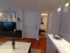 a living room with a flat screen tv and a living room at Timeless - Energy - Belém in Lisbon