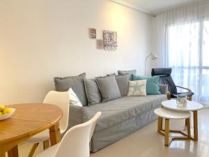 a living room with a couch and a table at REGIA BAHIA - Cabo Roig - SEA VIEW in Playas de Orihuela