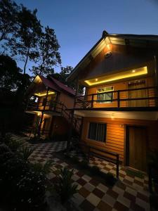 a house with a staircase on the side of it at The PugMark Wildlife Resort in Jyoti Gaon