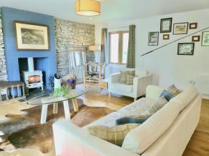 a living room with a couch and a fireplace at The Byre - by Where Stags Roar in Newtonmore