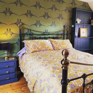 a bedroom with a bed and a wall with drawings of dolphins at The Byre - by Where Stags Roar in Newtonmore