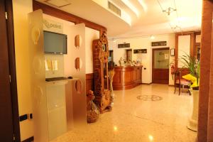 a living room with a refrigerator and a kitchen at Hotel Scaldaferro in Sandrigo