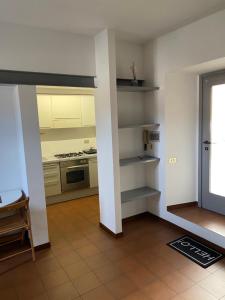 a kitchen with white cabinets and a stove top oven at vicolo forno in Mercallo