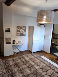 a bedroom with a large bed and a table at Casale la Decima in Budrio
