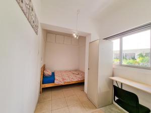 een kleine slaapkamer met een bed en een raam bij City View Rooms in Larnaka