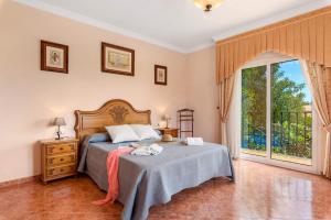 a bedroom with a bed and a large window at Villa Serena - PlusHolidays in Calpe +35 photos