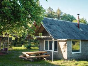 a picnic table in front of a house at Paluküla Saunas and Glamping in Paluküla