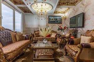 a living room with couches and a chandelier at Marmaray Hotel in Istanbul