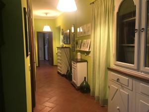 a hallway of a home with green walls and a tile floor at Casa Giulia in Vigliano d'Asti +4 photos