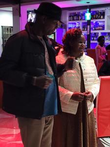 a man and a woman standing in a bar at STERLEON HOTEL RIVERSIDE in Nairobi