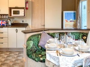 a table with plates and glasses on it in a kitchen at Retro Retreat in Goodrington