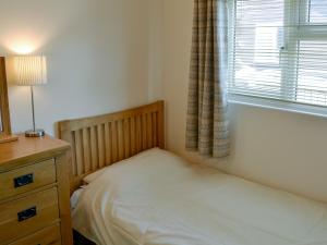 a small bedroom with a bed and a window at Silver Bream in Brundall