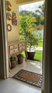 an open door to a porch with a bench at Solar Água Pipa 119 in Pipa