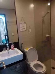 a bathroom with a sink and a toilet and a shower at Boracay Condocation in Boracay