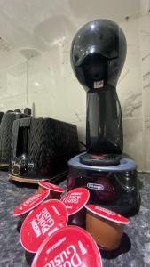 a coffee maker sitting on top of a counter with red signs at Seymour - Marble Arch, Mayfair Apartments hosted by Maysa London in London