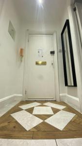 Cette chambre dispose d'une porte blanche et de carrelage. dans l'établissement Seymour - Marble Arch, Mayfair Apartments hosted by Maysa London, à Londres