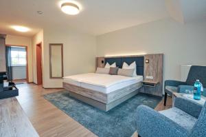 Postel nebo postele na pokoji v ubytování Hotel Grasberger Hof GmbH