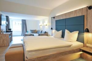 Postel nebo postele na pokoji v ubytování Hotel Grasberger Hof GmbH