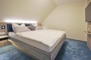 Postel nebo postele na pokoji v ubytování Hotel Grasberger Hof GmbH
