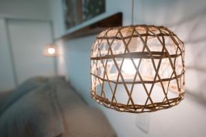 a metal light fixture hanging from a wall at Cabaña 1920 - frente a viñedo in San Rafael +20 photos