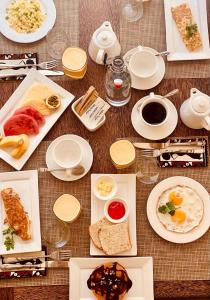 a wooden table with plates of food on it at Helwas Zanzibar Beach Hotel in Bwejuu