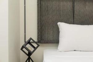 a bedroom with a bed with a white pillow at Tsimiski #apartment (one bedroom) in Thessaloniki