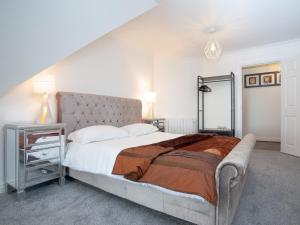 1 dormitorio con 1 cama grande y espejo en Pochin House Apartment 16 en St Austell