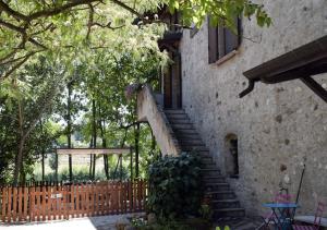 a building with a staircase leading up to a window at Casa Vacanze Cascina Campagnola in Pozzolengo