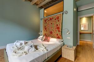 a bedroom with a bed with a red head board at Mamo Florence - Frida Luxury Apartment in Florence