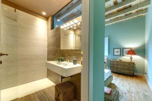 a bathroom with a sink and a mirror at Mamo Florence - Frida Luxury Apartment in Florence