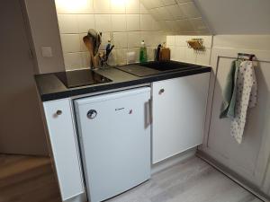 a kitchen with a sink and a counter top at Studio au 2e étage de notre maison de ville in Caen