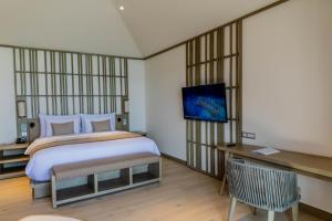 Postel nebo postele na pokoji v ubytování Kagi Maldives Resort & Spa