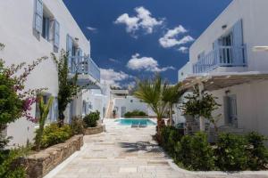 a courtyard of a villa with a swimming pool at 'Nepheli' Mykonean Suite in Ornos