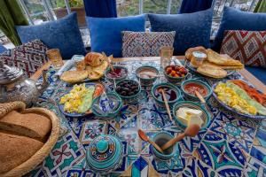 a table with plates of food on top at Riad Mosaic in Chefchaouen