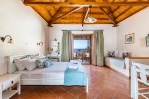 a bedroom with a bed and a view of the ocean at Althea Accommodation in Agnontas