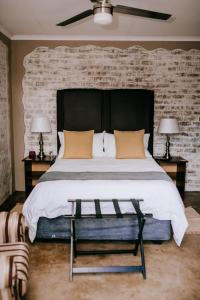 a bedroom with a large bed with a brick wall at La Bendicion in Witbank