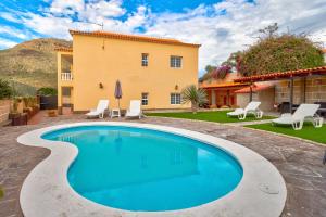 a swimming pool in front of a house at Bonita Casa Arianny By Paramount Holidays in Arona