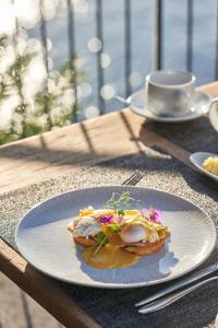 a plate of food on a table with a cup of coffee at Les Suites at The Cliff Bay - PortoBay in Funchal