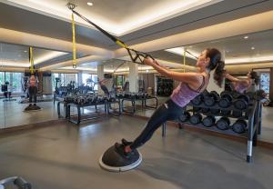 a woman in a gym with a skipping rope at Les Suites at The Cliff Bay - PortoBay in Funchal