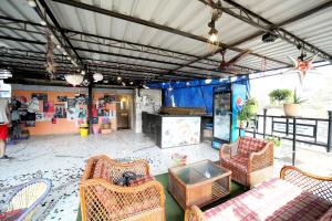 a living room with wicker chairs and a table at MAPLE SOCIAL HUBZ-HOSTEL in Mumbai