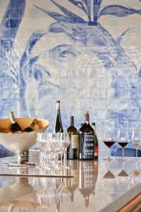 a group of wine bottles and glasses on a table at Les Suites at The Cliff Bay - PortoBay in Funchal