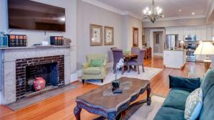 a living room with a fireplace and a table at 201 York #3 · Homey Downtown 2 Bedroom Steps from the River in Savannah