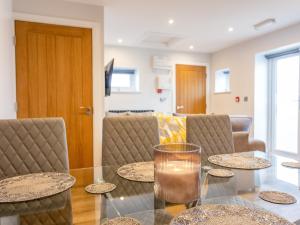 a dining room with a glass table and chairs at The Linden Suite - Uk40475 in Willerby
